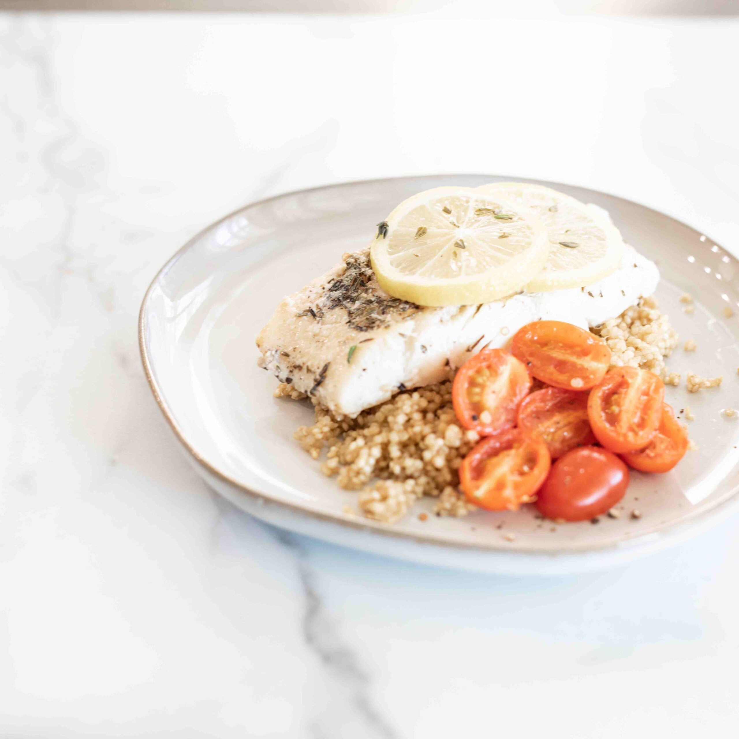 Tomatoes, cod and lemons over a bed of grains