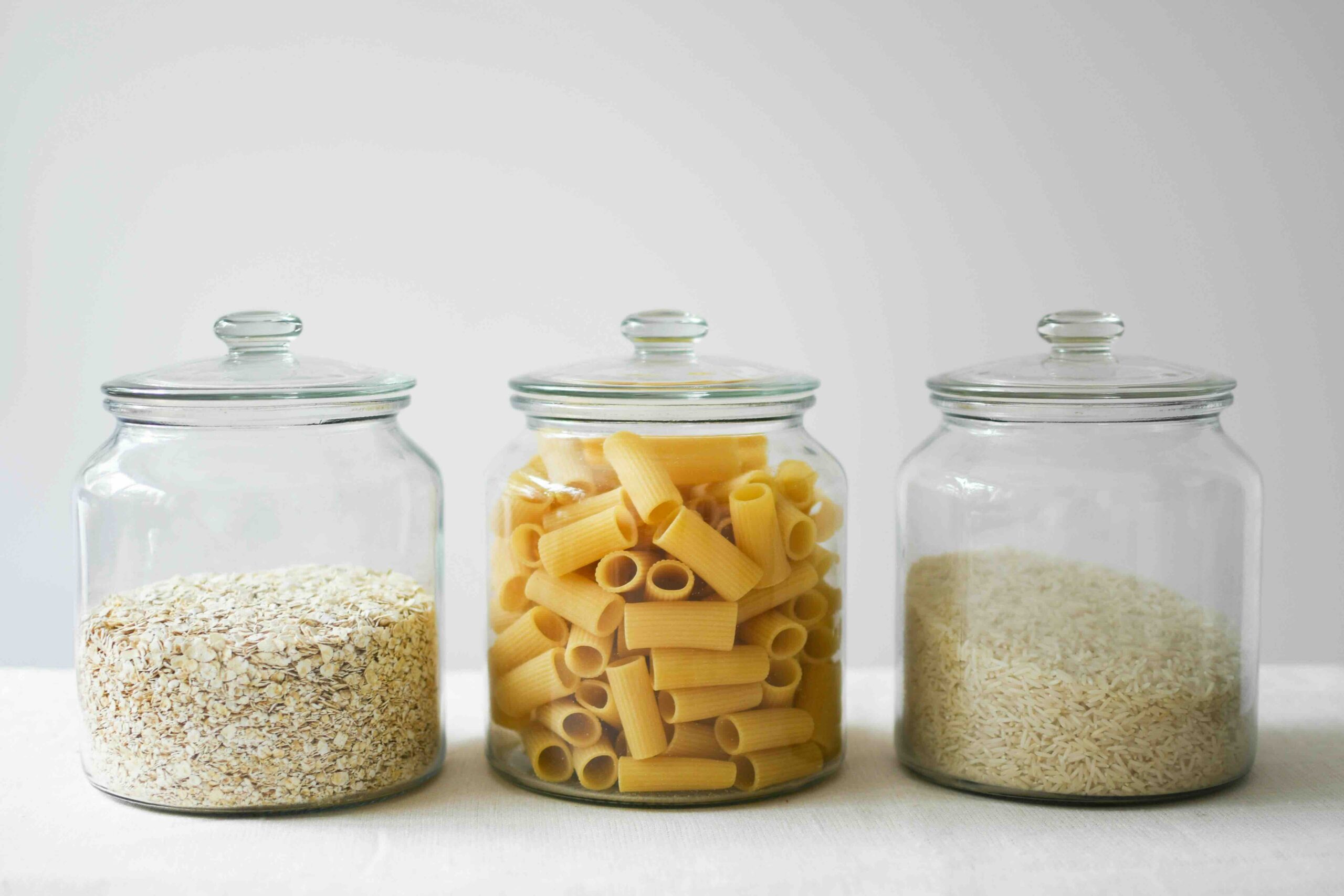 Rice, oatmeal, pasta in 3 different class jars