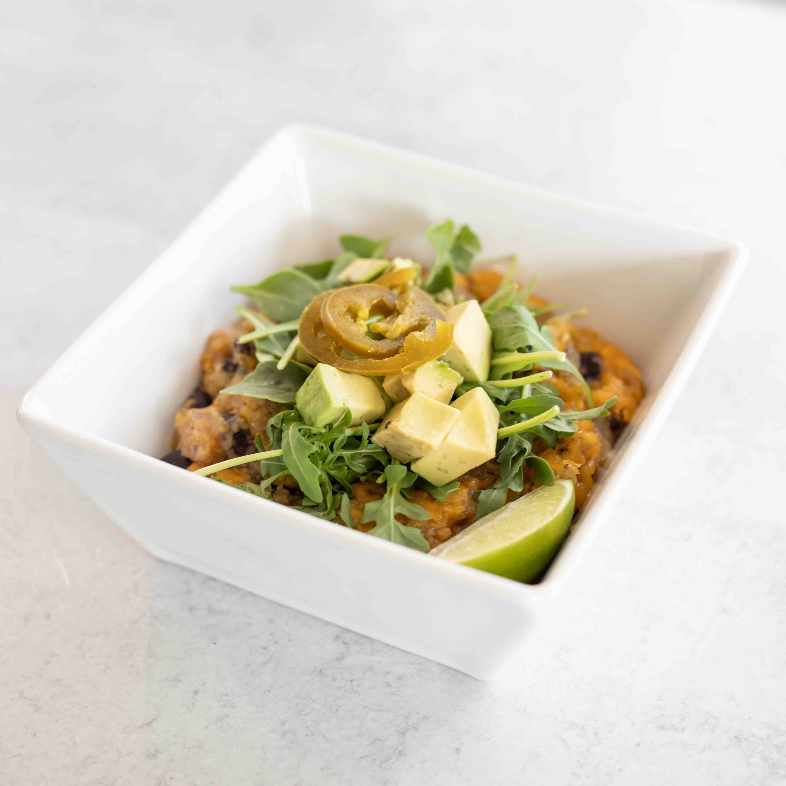 Meal in a white bowl with a marble background