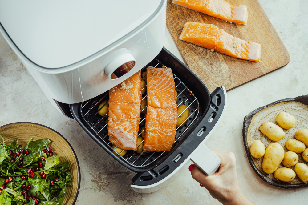 Salmon being cooked in a white air fryer