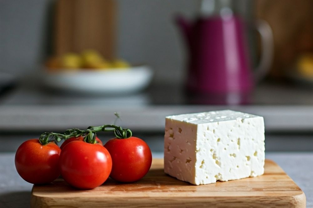 tomatoes and feta on a cutting board
